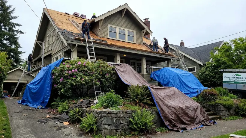 Tarps protecting the landscaping of a two-story home during a roof replacement.
