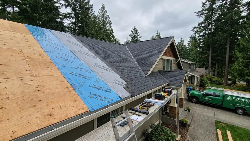 The different layers of a complete roofing system including underlayment and shingles.